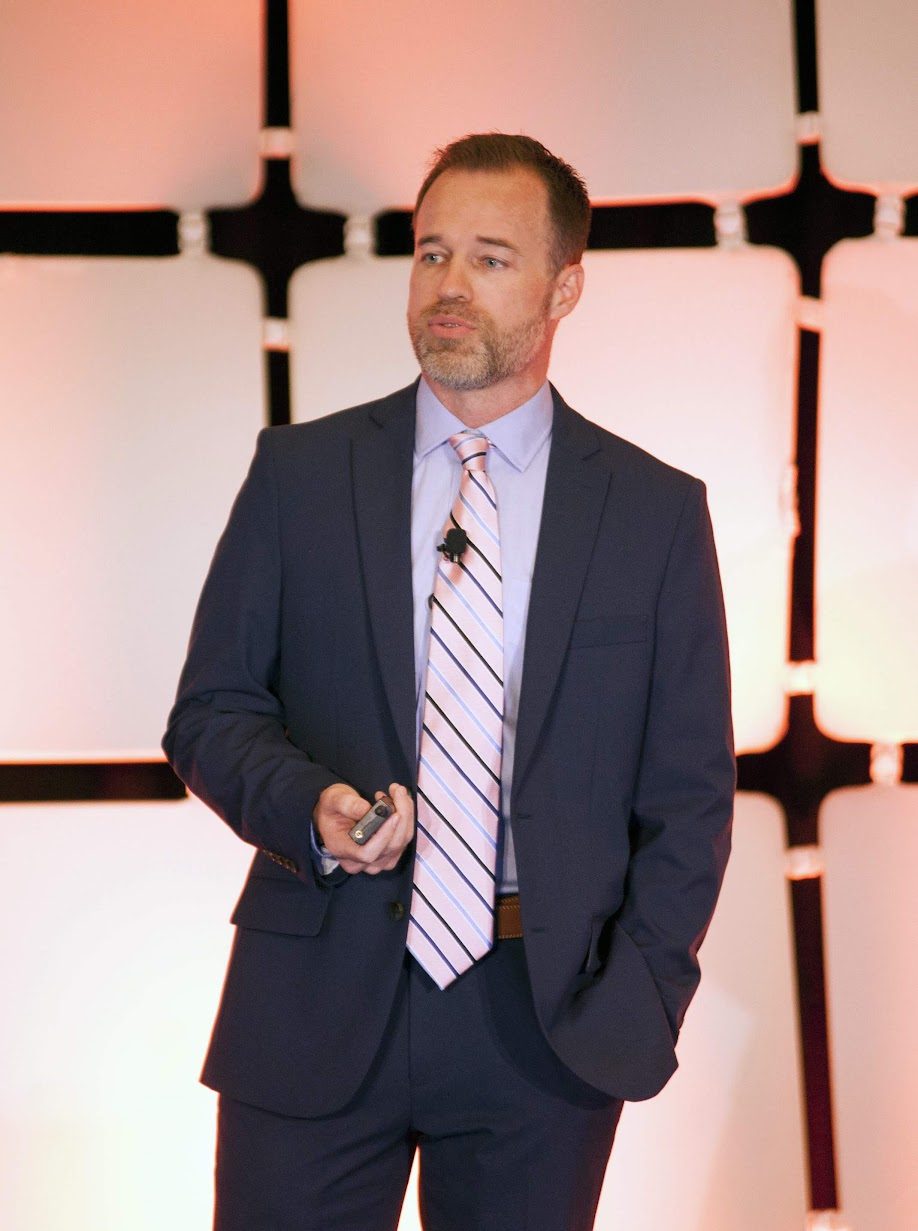 Brian delivering a keynote presentation on stage